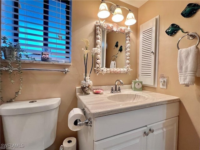 half bathroom with vanity and toilet