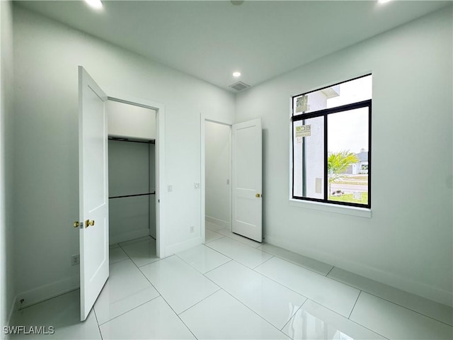 unfurnished bedroom with light tile patterned floors, baseboards, visible vents, and recessed lighting