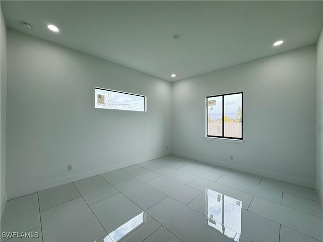 unfurnished room featuring recessed lighting, baseboards, and tile patterned floors