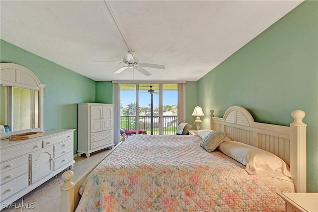 bedroom with light tile patterned floors, floor to ceiling windows, a ceiling fan, and access to exterior