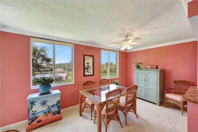 dining room featuring ornamental molding, light tile patterned flooring, a textured ceiling, and a ceiling fan