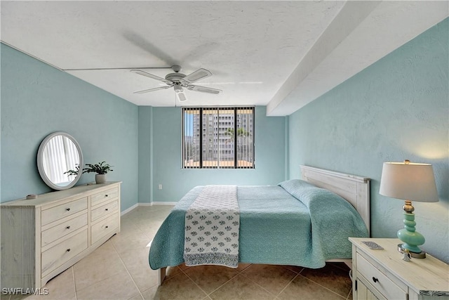 bedroom featuring light tile patterned flooring, ceiling fan, and baseboards