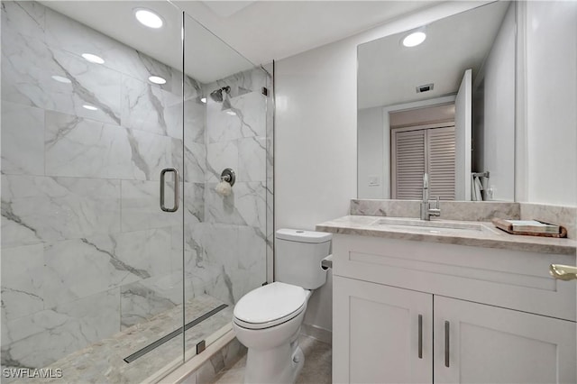 bathroom featuring vanity, a marble finish shower, toilet, and recessed lighting