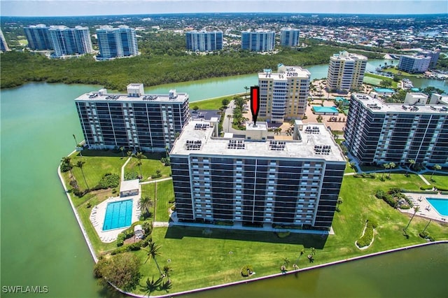 birds eye view of property featuring a water view and a city view