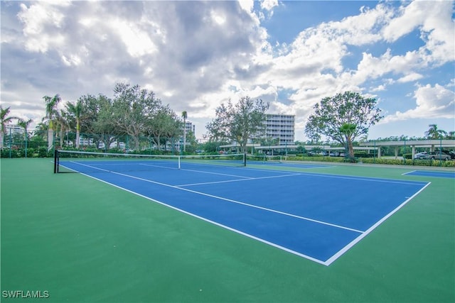 view of tennis court featuring fence