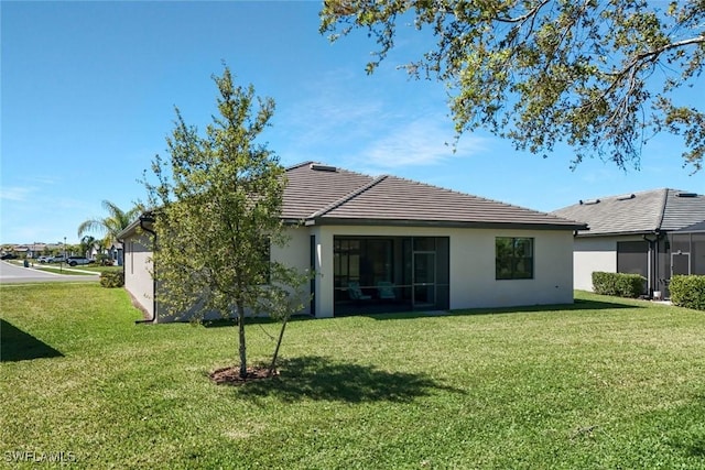 1821 Lema Ct, Naples, FL 34120 - back of property with a lawn, stucco siding, and a tile roof