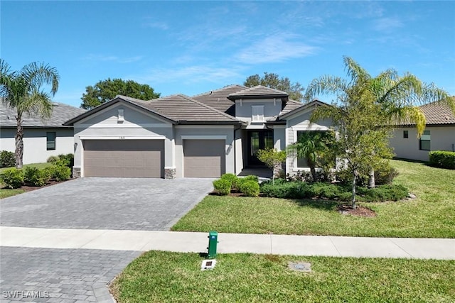 1821 Lema Ct, Naples, FL 34120 - view of front of house featuring a tile roof, a front yard, a garage, decorative driveway, and stucco siding