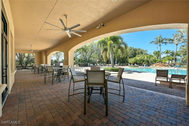 1821 Lema Ct, Naples, FL 34120 - view of patio featuring a ceiling fan, a community pool, and outdoor dining space