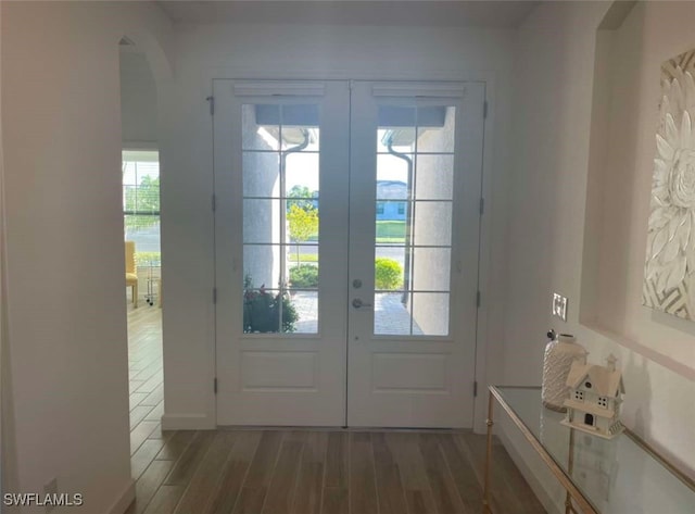 1821 Lema Ct, Naples, FL 34120 - doorway with arched walkways, french doors, and wood finished floors
