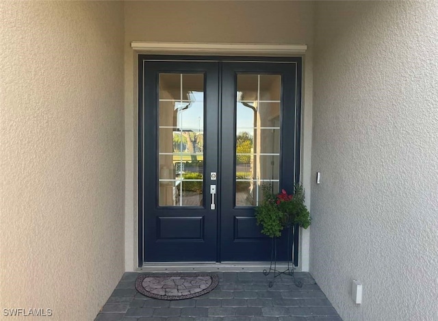 1821 Lema Ct, Naples, FL 34120 - view of exterior entry with french doors and stucco siding