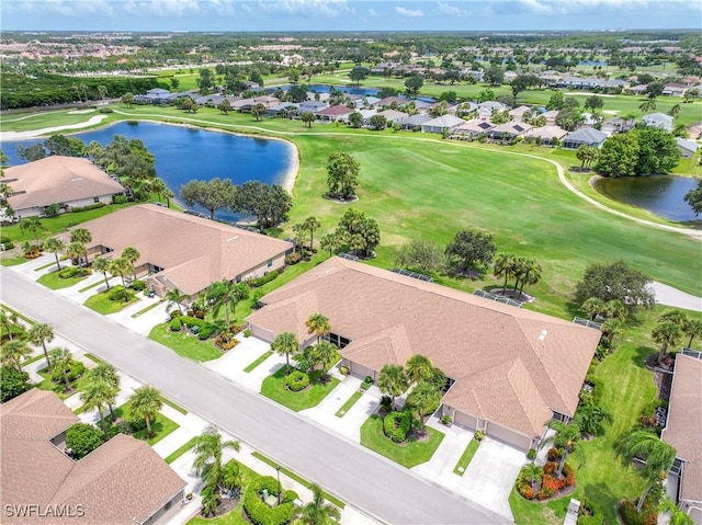 aerial view featuring view of golf course, a water view, and a residential view