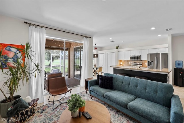 living room with recessed lighting, visible vents, and light tile patterned floors