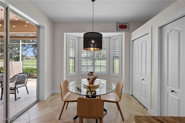 dining area featuring baseboards