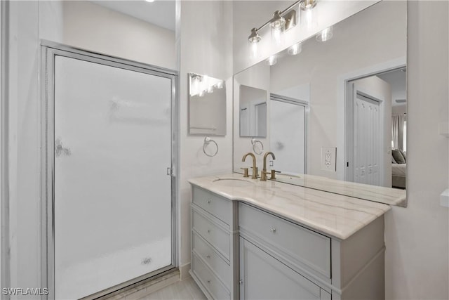 full bathroom featuring a stall shower and vanity