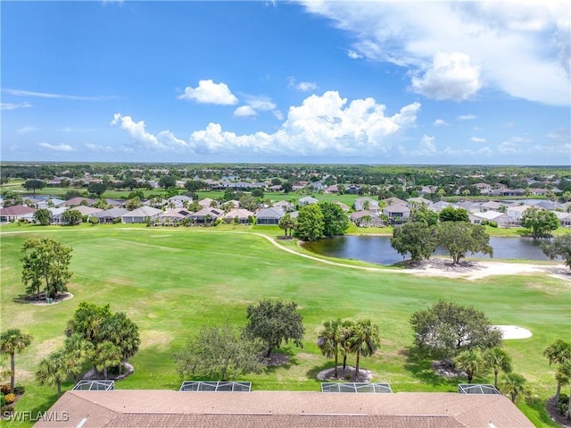 drone / aerial view with a residential view, a water view, and golf course view