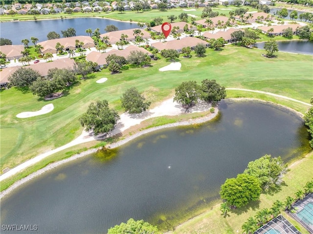 aerial view with view of golf course, a water view, and a residential view