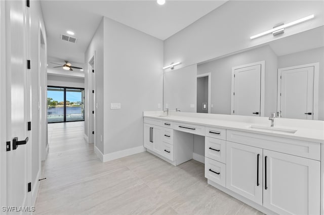 full bathroom featuring baseboards, visible vents, double vanity, ceiling fan, and a sink