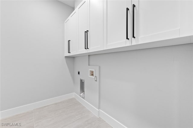 laundry room featuring hookup for a washing machine, baseboards, light wood finished floors, hookup for an electric dryer, and cabinet space