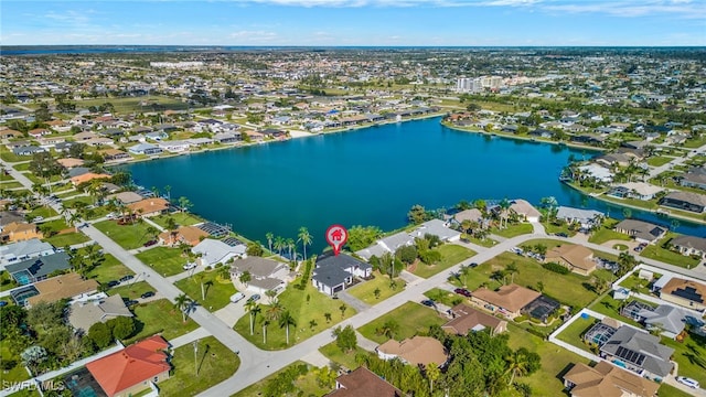 drone / aerial view with a residential view and a water view