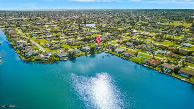 drone / aerial view with a residential view and a water view