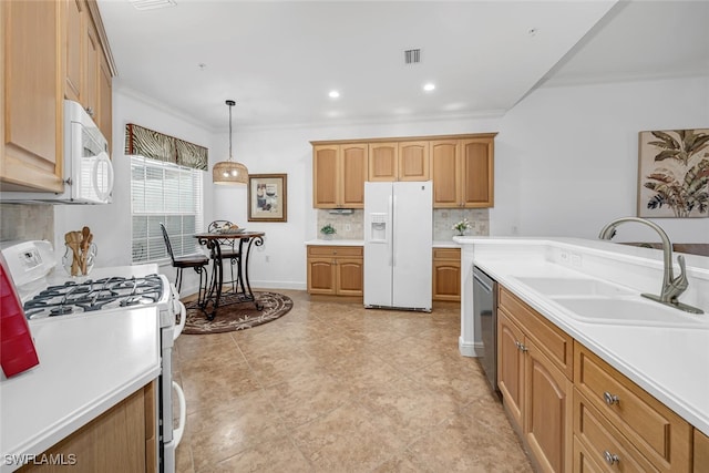 kitchen with a sink, backsplash, white appliances, crown molding, and light countertops