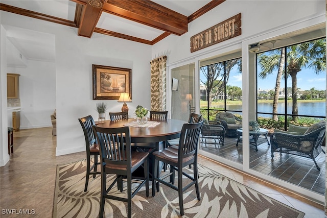 dining room featuring beam ceiling, light tile patterned floors, baseboards, and a water view