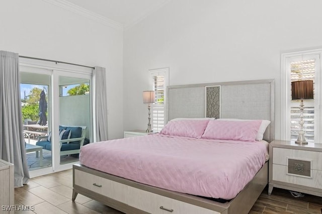 5311 Harborage Dr, Fort Myers, FL 33908 - bedroom with access to outside, multiple windows, crown molding, a towering ceiling, and wood finished floors