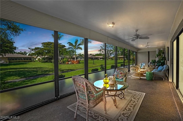 sunroom featuring a ceiling fan