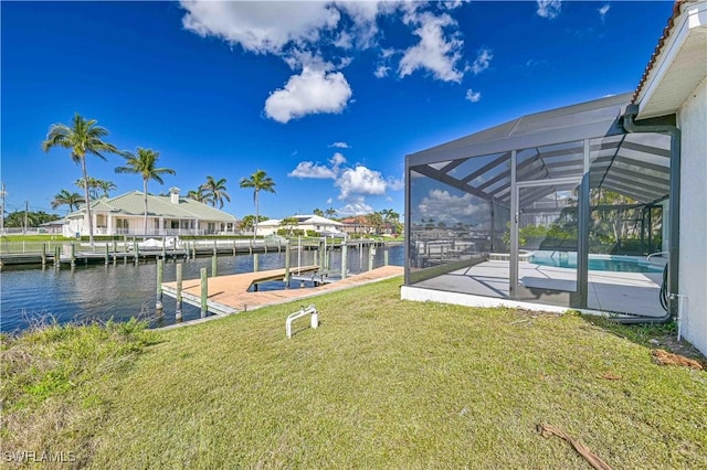 view of dock featuring a lanai, a water view, an outdoor pool, and a yard