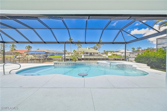 view of pool featuring a lanai, a patio area, a pool with connected hot tub, and a residential view