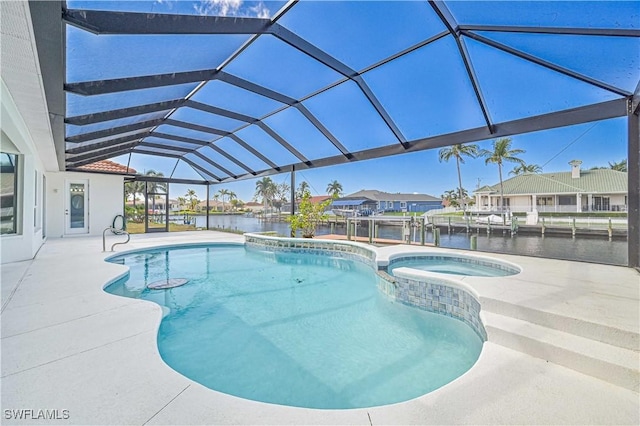 view of swimming pool featuring glass enclosure, a water view, a pool with connected hot tub, a dock, and a patio area