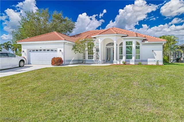 mediterranean / spanish house featuring a tiled roof, an attached garage, decorative driveway, a front lawn, and stucco siding