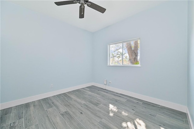 unfurnished room featuring ceiling fan, baseboards, and wood finished floors