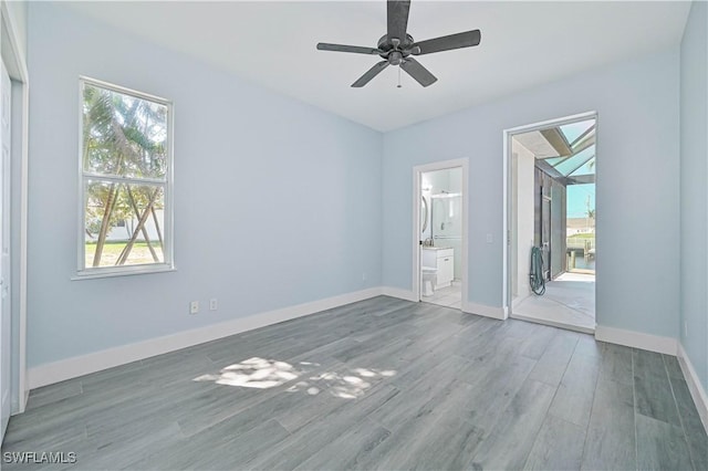 spare room featuring ceiling fan, wood finished floors, and baseboards