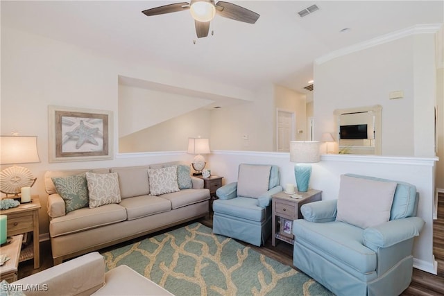 living area with wood finished floors, ceiling fan, lofted ceiling, ornamental molding, and visible vents
