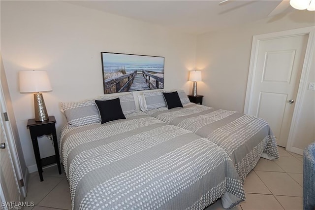 bedroom featuring ceiling fan, baseboards, and light tile patterned flooring