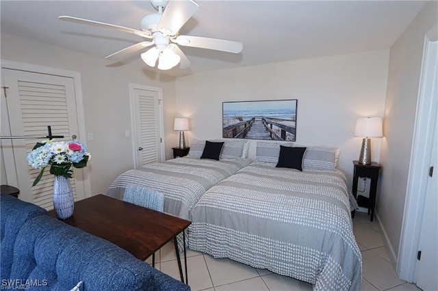 bedroom featuring light tile patterned floors, ceiling fan, and baseboards