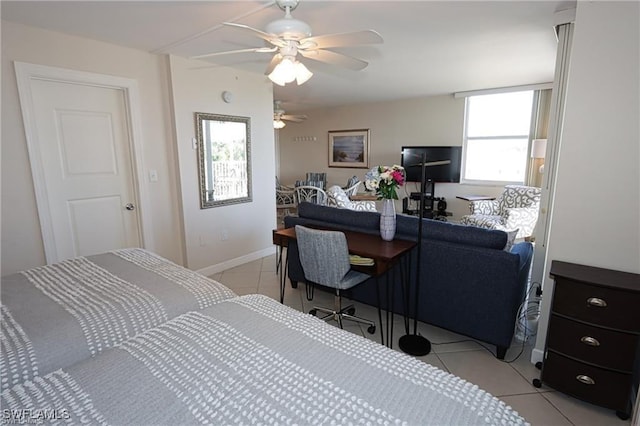 bedroom featuring ceiling fan, light tile patterned flooring, and baseboards