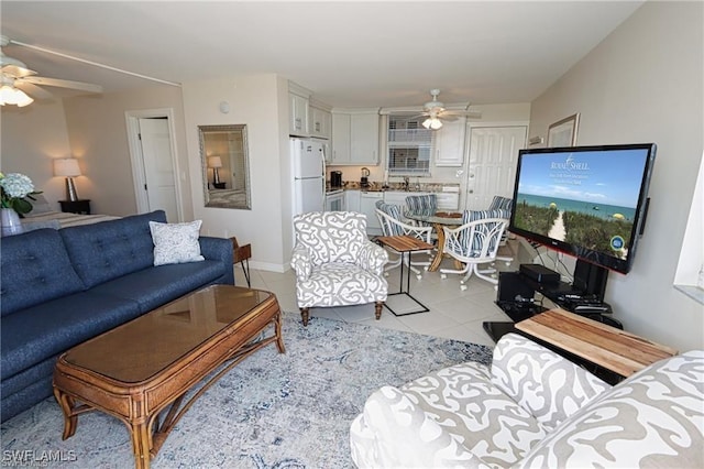 living area featuring ceiling fan and light tile patterned floors