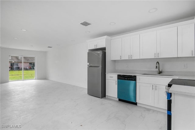 kitchen featuring visible vents, freestanding refrigerator, white cabinetry, a sink, and dishwashing machine