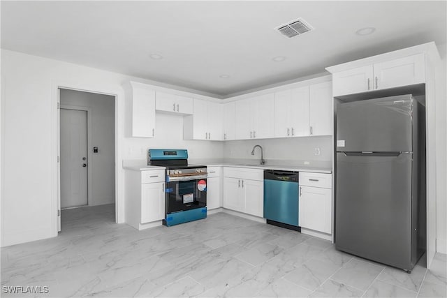 kitchen featuring appliances with stainless steel finishes, marble finish floor, light countertops, and a sink