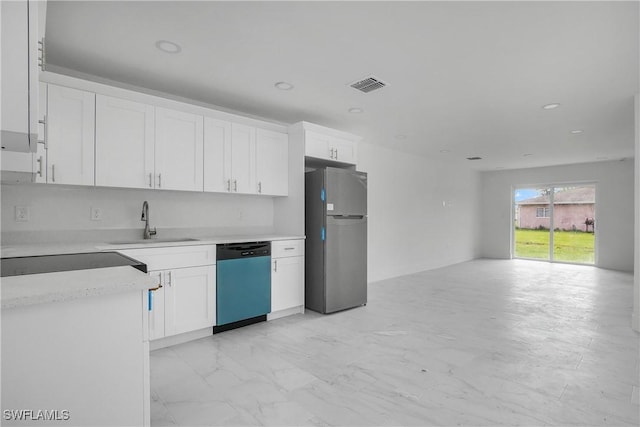 kitchen featuring visible vents, dishwasher, freestanding refrigerator, light countertops, and a sink