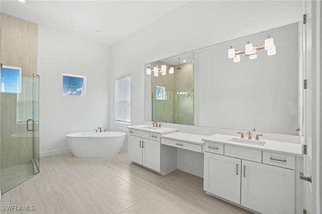 full bath featuring vanity, a shower stall, and a freestanding tub