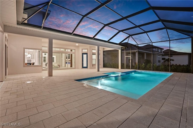 view of swimming pool with a patio, a pool with connected hot tub, and a lanai