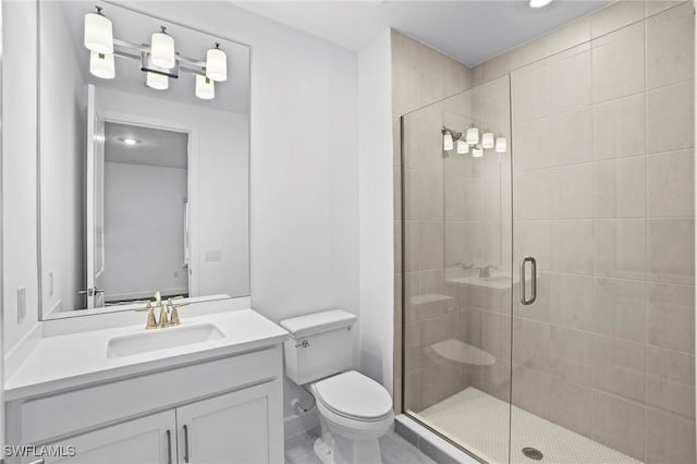 full bathroom featuring a stall shower, vanity, and toilet