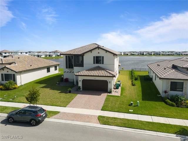 view of front facade featuring a garage, a residential view, a tiled roof, decorative driveway, and a front lawn