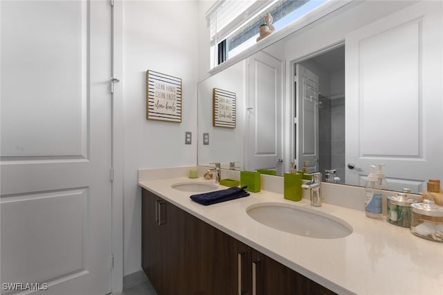 full bath featuring walk in shower, a sink, and double vanity