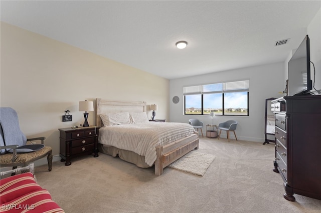 bedroom with light carpet, baseboards, and visible vents