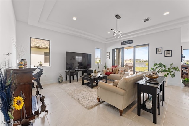 living room with light tile patterned floors, a raised ceiling, visible vents, and recessed lighting