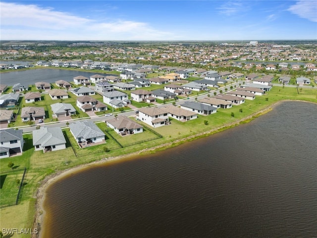 drone / aerial view with a water view and a residential view